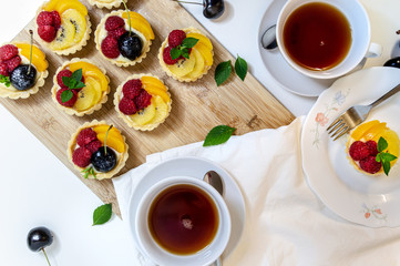 top down view of a fruit tartlet tea time scene