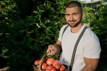 young man holding a tomato