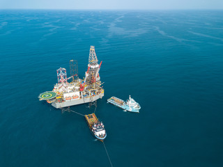 Aerial view offshore jack up rig at the offshore location during sunset
