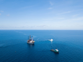 Offshore jack up rig and tow vessels during the rig move operation at the offshore location