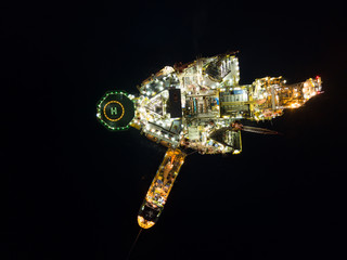 Aerial view offshore jack up rig at the offshore location during sunset