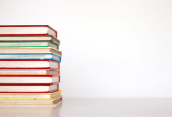 Pile of colorful books over white background