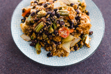 plant-based food, vegetables casserole with black beans and cous cous