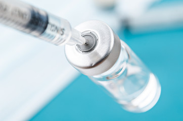 Vaccine vial dose with needle syringe, medical concept vaccination.