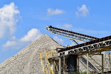 Raw product being stock piled via conveyor at a concrete processing facility.