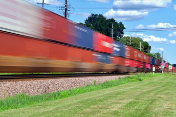 A speeding intermodal freight train is a blur as it speeds through Geneva, Illinois a western...