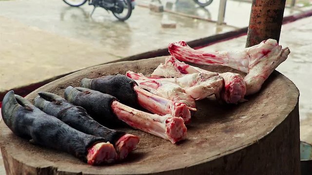 Cow hooves and bones cut and displayed for cooking outdoors