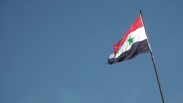 Slow Motion of Syrian National Flag Waving on Pole, Blue Sky Background