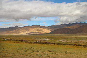 Fototapeta na wymiar View of the mountains and dramatic sky near Tingri on the way to Everest Base Camp, Tibet, China