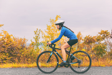 Obraz premium Bike cyclist outdoor woman biking road bicycle in autumn foliage nature.