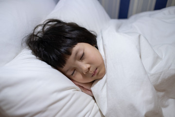 asian kid sleep on bed, sick child
