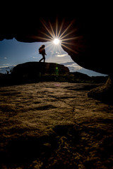 silhouette of a woman standing on a rock