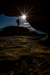 silhouette of a women standing on a rock