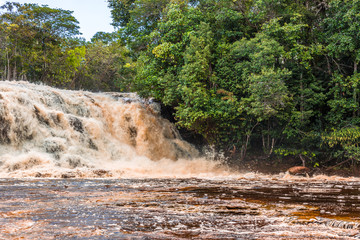 Fast rapid red waters from the Amazon River at the cascading cachoeira de iracema waterfall...