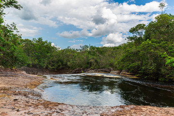Naklejka na ściany i meble Pool of water at the top of Cachoeira de Iracema waterfall that leads into the Amazon River in the middle of the jungle & rainforest at Presidente Figueiredo in the Amazonas, Brazil, South America