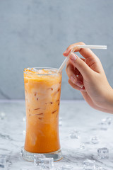 Iced milk tea on marble pattern floor It is a delicious and nutritious relaxation drink.