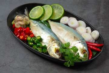 Hot and Spicy Mackerel Decorated with Thai food ingredients, World Food Day.