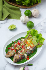 Hot and Spicy Mackerel Decorated with Thai food ingredients, World Food Day.