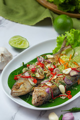 Hot and Spicy Mackerel Decorated with Thai food ingredients, World Food Day.