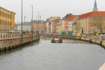 The Hop on Hop off boat for tourist in the river near Christiansborg Palace in Copenhagen, Denmark