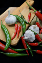 Fresh Red Chilies And Garlic On Wooden Cutting Board