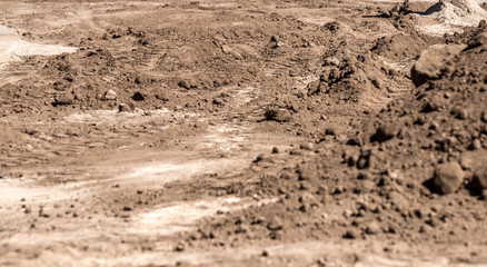 truck tire wheels, bobcat. on brown dirt road.