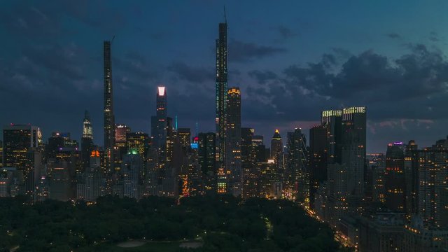 AERIAL HYPERLAPSE: Day to Night Motion Timelapse of New York from Central Park with beautiful city lights.