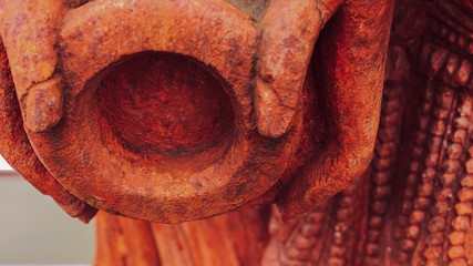A close up of a sculpture of a lady holding pot by her side depicting ancient indian culture