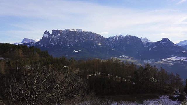 Panning view of some of the mountains of the dolomites (Schlern Sciliar) in the alps during winter. Italy from the viewpoint near Klobenstien near Bolzano Bozen, Italy