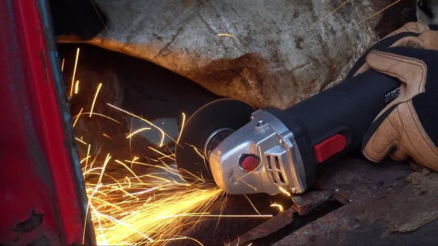 Angle Grinder on Rusty Truck Metal Cutting Sparks from Side
