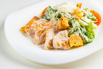 caesar salad with chicken on the white background