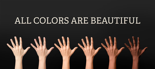 Hands of different people and text ALL COLORS ARE BEAUTIFUL on dark background. Stop racism