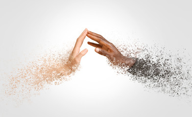 Hands of Caucasian woman and African-American man reaching out to each other on color background....