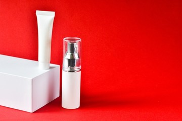 Design of natural cosmetic cream, serum, skincare blank bottle packaging, bio organic product on a red background. beauty and spa concept. 
