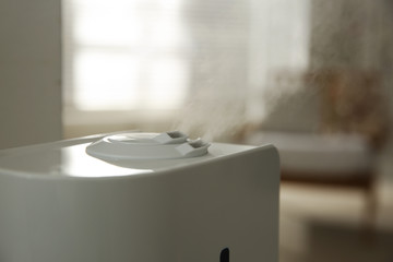 Modern humidifier on blurred background, closeup view