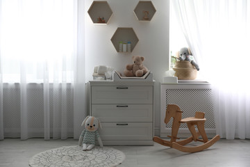 Beautiful baby room interior with toys and modern changing table © New Africa