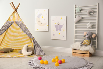 Stylish child's room interior with adorable paintings and play tent © New Africa