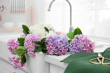 Beautiful bouquet of hydrangea flowers in sink, closeup