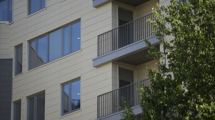Fototapeta na wymiar New microdistrict, Windows and balconies of Apartment building in Residental Area