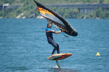 MALCESINE, ITALY - Jul 08, 2020: Wing-foil surfer on the lake Garda in Italy.