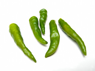 green chili peppers on white background