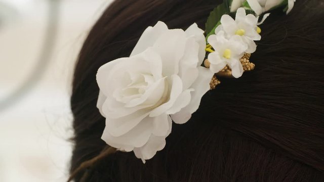 Macro Closeup of Crown Floral Wreath of white flowers in hair of bridesmaid