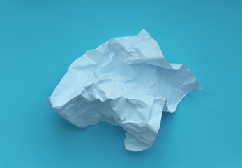 Crumpled paper  isolated on blue background .