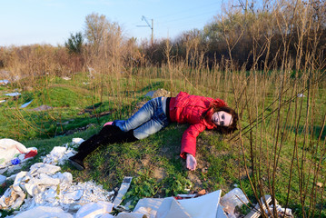 Dead woman lying on landfill
