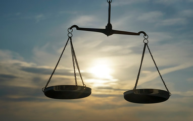 Scales of Justice background - legal law concept. a balance is hand-held, sky is the...