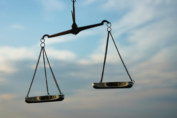Scales of Justice background - legal law concept. a balance is hand-held, sky is the...