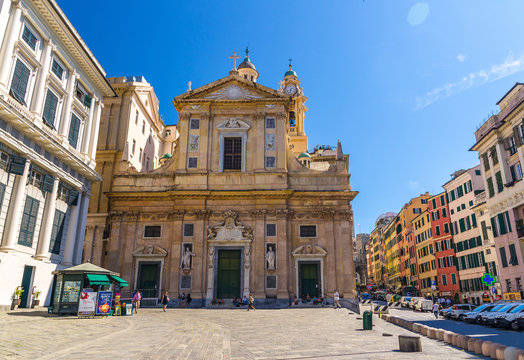 Genoa, Italy, September 11, 2018: Chiesa dei Santi Ambrogio e Andrea detta del Gesu catholic church, row of colorful buildings on Piazza Giacomo Matteotti square in historical centre Genova, Liguria