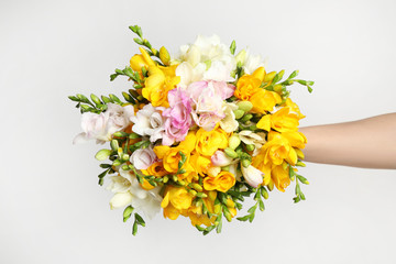 Beautiful colorful freesia bouquet on grey background, top view