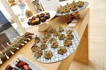 canapés setup for an event on a wooden table.