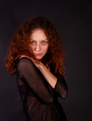 Beautiful red-haired woman with fair skin and curly hair, portrait